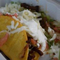 Super Tacos (2) · Choice of meat, corn tortillas, melted cheese, guacamole, pico de gallo, and sour cream.