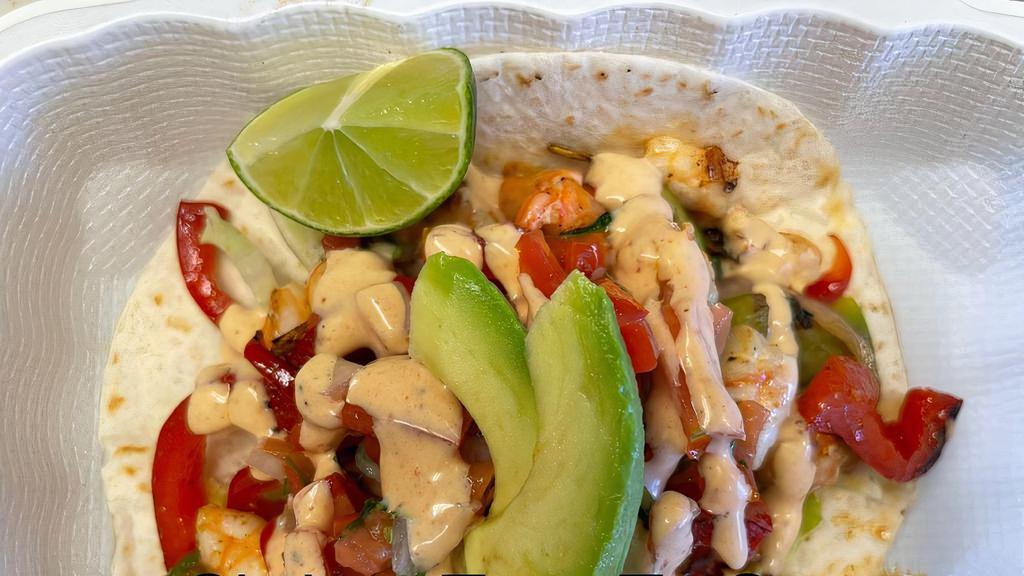 Shrimp Tacos (2) · Grilled shrimp, flour tortilla, lettuce, grilled veggies, pico de gallo, special sauce and slice of avocado.