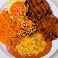 Thursday - Carne Asada · Flank steak broiled and served with  rice, beans, lettuce, guacamole, and pico de gallo. Cor...