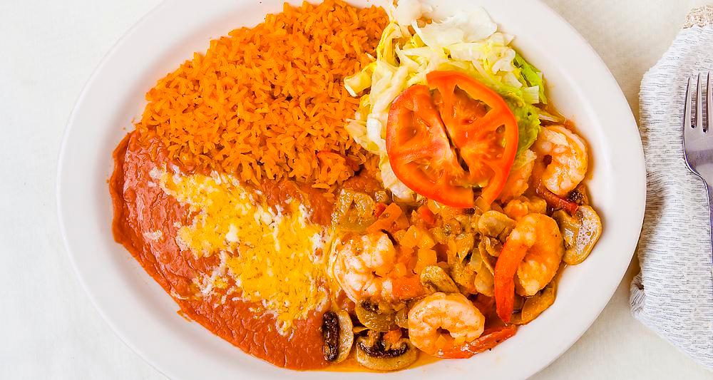 Camarones al Mojo de Ajo · Butterflied prawns and mushrooms sautéed in butter, garlic, onions and spices. Served with lettuce, guacamole, rice and beans.