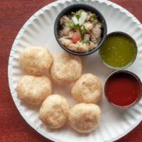 Pani Puri · Crispy puffed wafers served with spicy mint water, chutneys, potatoes and chickpeas.