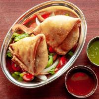 Samosa · Vegetarian. Sautéed potato and green peas stuffed in triangle pastry and fried.