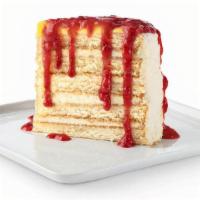 New! Freckled Lemonade® Cake · Light and refreshing lemon cake layered with lemon mousse and white chocolate bits, topped w...