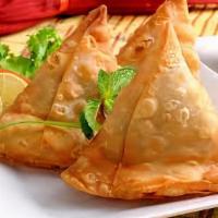 Samosa · 2 pieces. Veggie turnover, stuffed with potatoes, green peas, herbs and spices, served
with ...