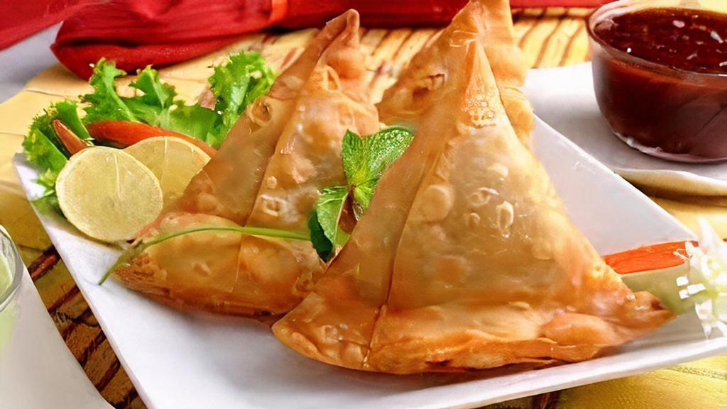 Samosa · 2 pieces. Veggie turnover, stuffed with potatoes, green peas, herbs and spices, served
with chutney.