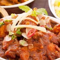 Karahi Chicken · Stir fried chicken with garlic, tomatoes, onions bell pepper and spices.