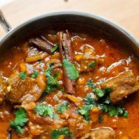 Goat Curry · Goat  (Bone in) meat cooked in blend of spices