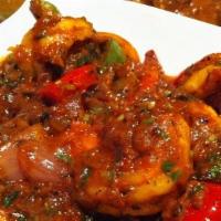 Karahi Prawns · Stir fried prawns with garlic, tomatoes, bell pepper and spices.