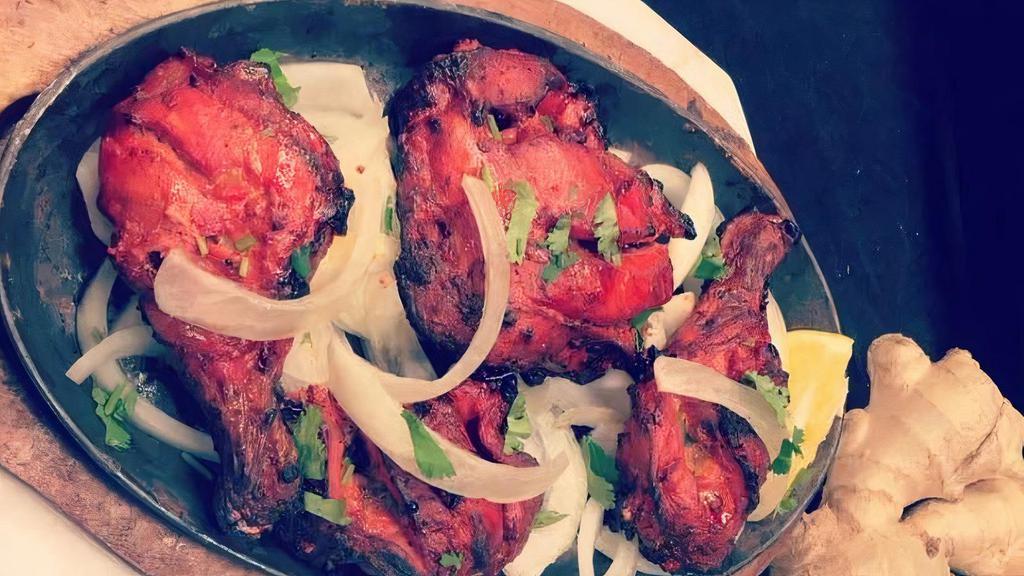 Chicken Leg Tandoori (2 Pieces) · Marinated chicken leg cooked in a clay oven.