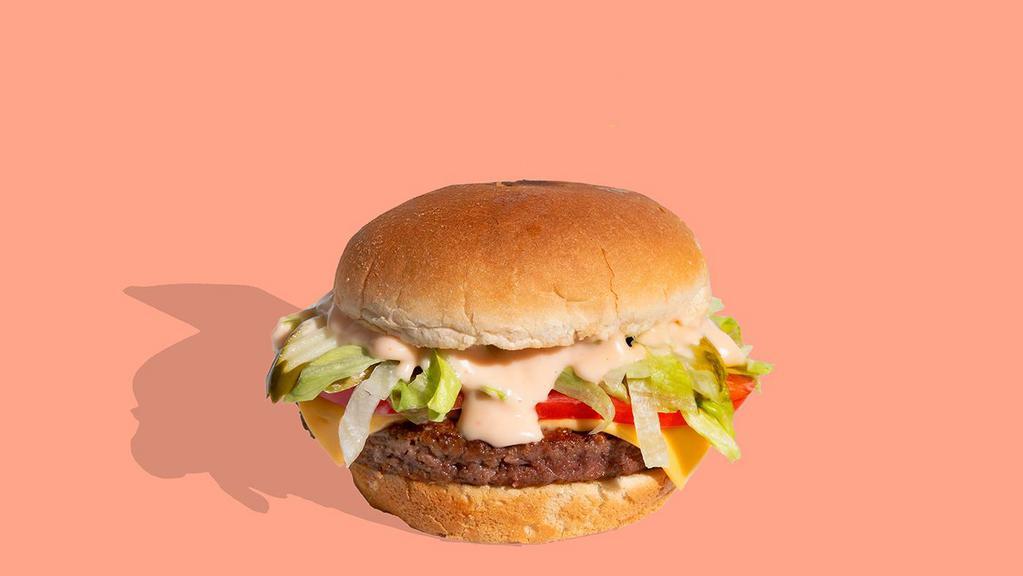 The Shop Burger · Our classic Shop Burger with perfectly seared ¼ lb Impossible™ Burger patty stacked with plant-based cheese sauce, shredded lettuce, fresh tomato, diced onions, dill pickle, and Shop Sauce on a toasted plant-based brioche bun. Drooling yet?