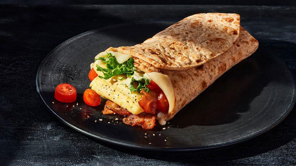 Bacon, Scrambled Egg & Tomato Wrap · 470 Cal. Applewood-smoked bacon, scrambled egg, grape tomatoes, emerald greens, aged white cheddar, garlic aioli, salt, and pepper in a Whole Grain Wrap. Allergens: Contains Wheat, Soy, Milk, Egg