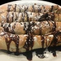 Sweet Love Sticks · Twisted baked dough, Nutella, mozzarella, served with powdered sugar and chocolate sauce