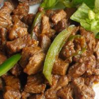 13. Tibs · Tender chopped beef sauteed to perfection with onions, green pepper tomato, then rapidly fri...