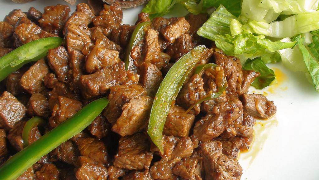 13. Tibs · Tender chopped beef sauteed to perfection with onions, green pepper tomato, then rapidly fried.