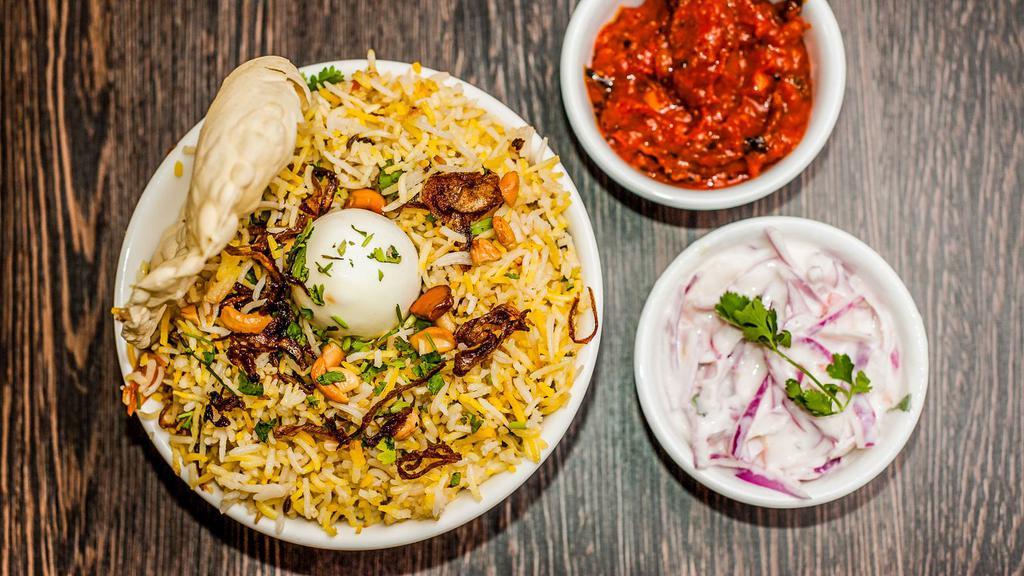 Chicken Biryani · The famed Malabar Chicken Biryani is made by layering an aromatic and herby chicken masala with fluffy rice, crunchy fried onions (birista), nuts, dried fruits.