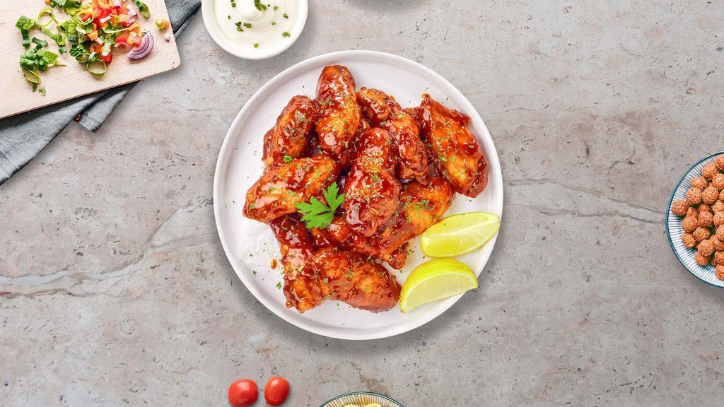Honey BBQ Wings · Fresh chicken wings, fried until golden brown, and tossed in honey and barbecue sauce. Served with a side of ranch or bleu cheese.