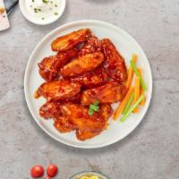 Buffalo Chicken Wings · Fresh chicken wings, fried until golden brown, and tossed in buffalo sauce. Served with a si...