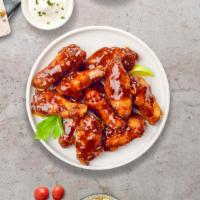 BBQ Chicken Wings · Fresh chicken wings, fried until golden brown, and tossed in barbecue sauce. Served with a s...