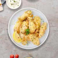 Garlic Parmesan Wings · Fresh chicken wings, fried until golden brown, and tossed in garlic and parmesan. Served wit...