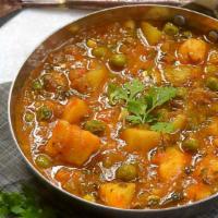 Vegan Aloo Mutter Curry · Potato with green peas, tomatoes, chopped onions with aromatic spices. Comes with Rice.