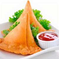 Vegan Samosa · Two hand crafted crispy Mixed Veggie samosas filled with peas and potatoes.