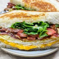 Awesome Brekky Sandwich · Choice of protein, scrambled eggs, shredded cheddar, fresh tomatoes, arugula, and garlic & m...