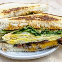 Pigs Gone Wild Brekky Sandwich · Grilled mushroom, three slices bacon, cheddar cheese, scrambled eggs, arugula, and chipotle ...