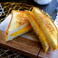 American Grilled Cheese · Melted shredded cheddar cheese on grilled bread (best choice: sourdough)!