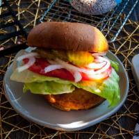 Fryed Chicken Sandwich · Fried chicken served on a brioche  bun, lettuce, tomatoes, onions, pickles, and choice of sa...