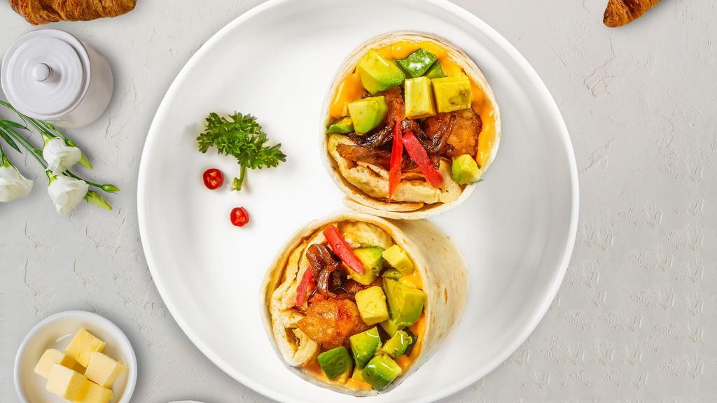 All In Avocado Breakfast Burrito · Two scrambled eggs with delicious breakfast sausage, crispy potatoes, melted cheese, avocado, tomato, and caramelized onions wrapped up in a flour tortilla.