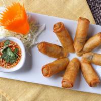 Vegetarian Spring Rolls · Crispy rolls served with peanut crunch in sweet sour sauce and cilantro.