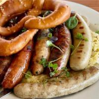 Wurst Family Platter · Choice of six sausages and comes with sauerkraut, spätzle, salad & fries - add a warmed bret...