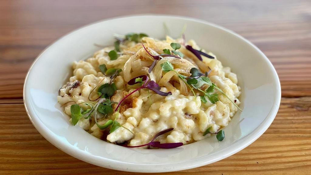 Classic Käsespätzle · House-made spätzle noodles baked with Swiss cheese. The Classic Käsespätzle is served with grilled onions.
