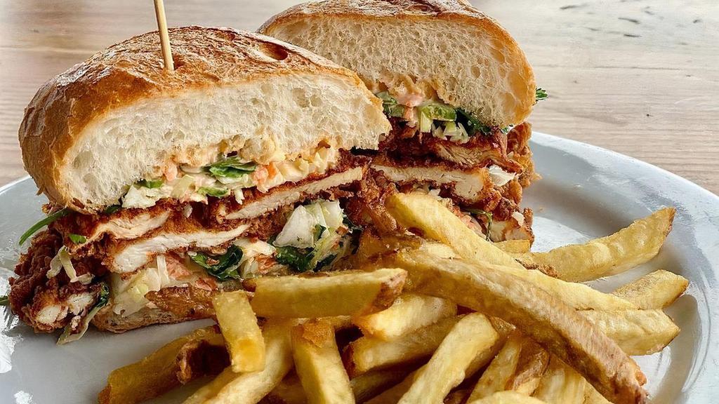 Oma's Chicken Sandwich · Buttermilk fried chicken breast, cilantro coleslaw, jalapenos, sriracha aioli on a roll. Served with fries or green salad.