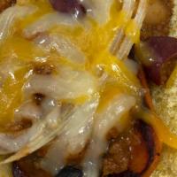 Vegetarian 3 Way Chili Cheese Dog · Plant based dog topped with veggie chili, shredded cheese, and onions on a toasted bun