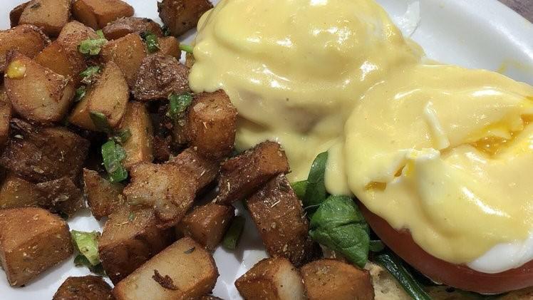 Eggs Florentine · 2 poached eggs, spinach and tomato slice, on English muffin with hollandaise sauce.