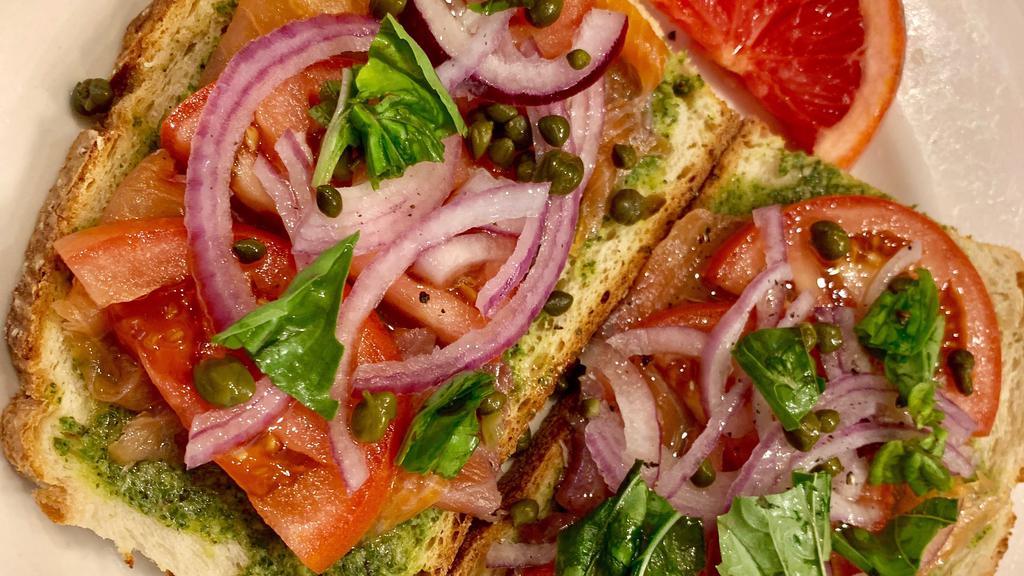 Alaskan · Smoked salmon, red onion, capers, pesto, basil, olive oil, tomato, and black pepper with choice of bread.
