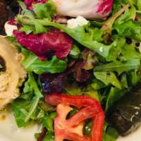 Mediterranean Plate Salad · Falafel, hummus, olives, feta cheese, tomatoes, red onion, dolmas, and basil. Served with pi...