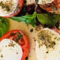 Caprese Salad · Classic Italian salad with tomatoes, olives, fresh mozzarella cheese, basil, olive oil, fres...