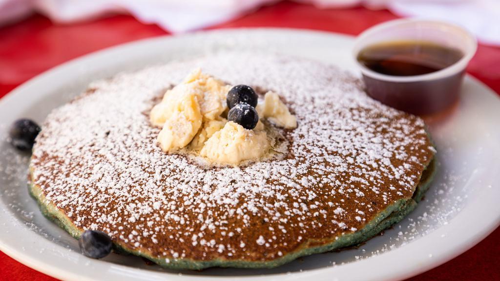Cornmeal Buttermilk Pancakes · Cornmeal buttermilk pancakes with butter and maple syrup.