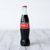 Coke · 12 fl oz. Made with cane sugar.