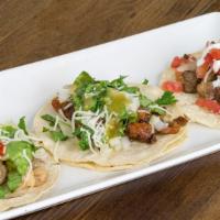 Tacos (3) · 3 per order. Includes Mexican rice, your choice of beans, lettuce, cabbage, onion, tomato, c...
