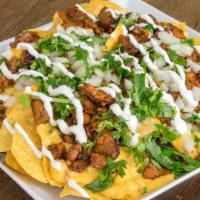Nachos · Includes tortilla chips, your choice of beans, lettuce, cabbage, onion, tomato, cilantro, sh...