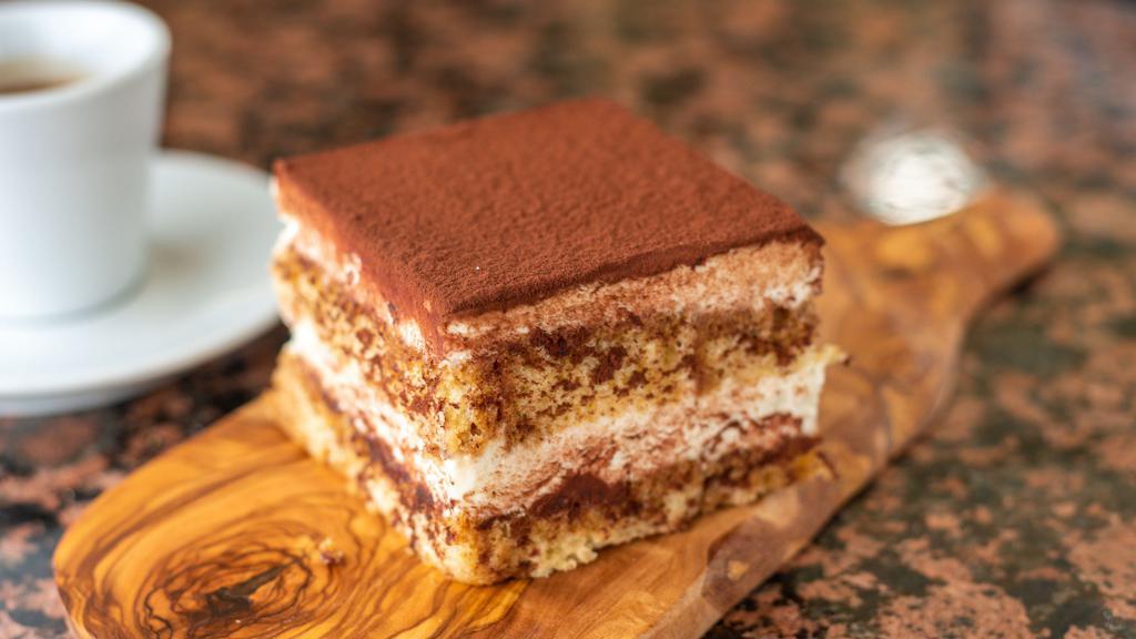 Tiramisu · Vanilla sponge cake soaked in espresso and rum with layers of mascarpone cream.