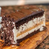 Black & White Slice · Vanilla and chocolate layers alternating with fresh whipped cream and topped with a rich fud...
