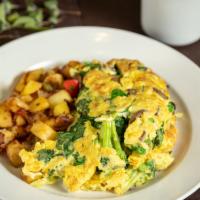 Veggie Omelet · Fluffy omelet filled with broccoli, spinach, bok choy, white onions, peapods and mushrooms.