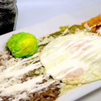 Manuel's Chilaquiles · Manuel's tomatillo sauce simmered with fresh corn tortillas, topped with queso fresco, sour ...