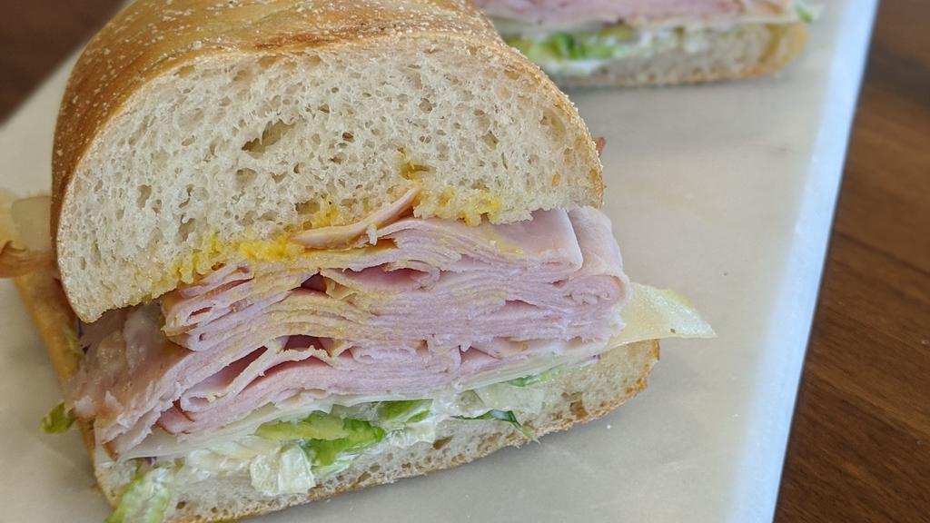 3. Black Forest Ham Sandwich · Black forest smoked ham on freshly baked sourdough. Includes lettuce, tomato, red onions, swiss cheese, house spread & mustard choice.
