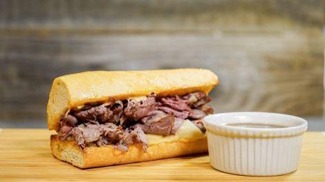 French Dip · Thinly Sliced Roast Beef, House Spread, Swiss Cheese and All-Natural Au Jus.