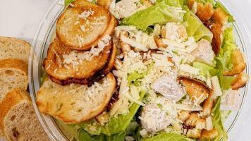 Grilled Chicken Caesar Salad · Chopped romaine, shaved parmesan, grilled chicken, sourdough croutons and Caesar dressing. S...